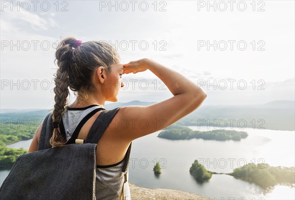 Rear view of young woman looking at view of lake