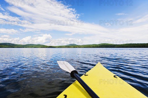 Bow of yellow kayak on lake