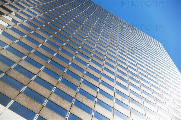 Low angle view of skyscraper against blue sky