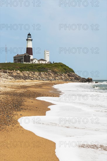 Lighthouse on cliff over sea