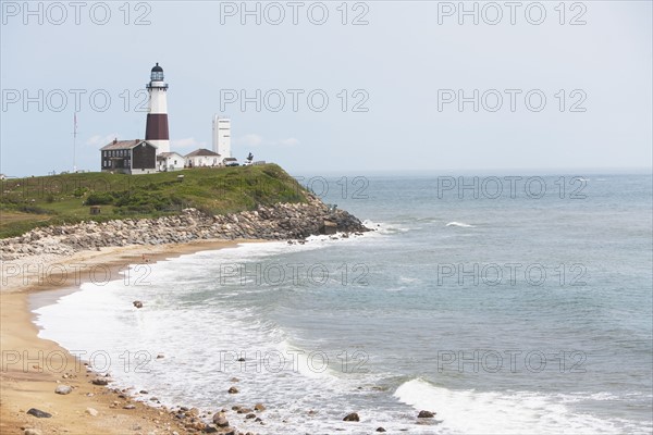 Lighthouse on cliff over sea