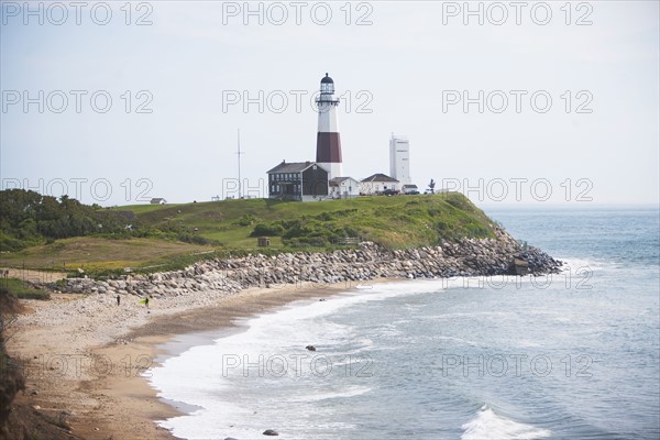 Lighthouse on cliff over sea