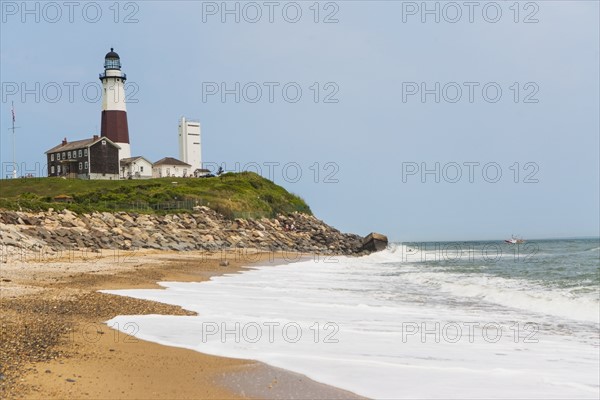 Lighthouse on cliff over sea