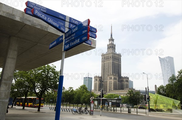 Sign post with Palace of Culture and Science in background