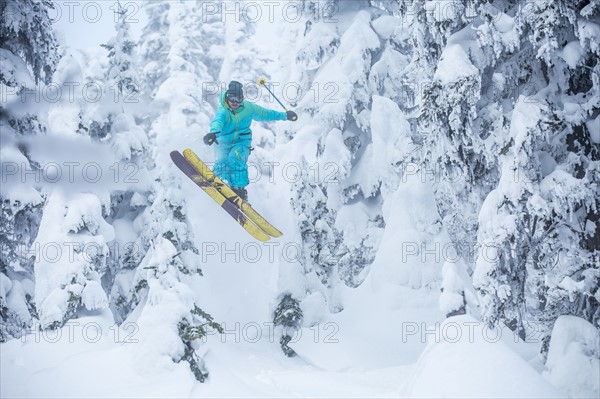 Skier jumping in forest