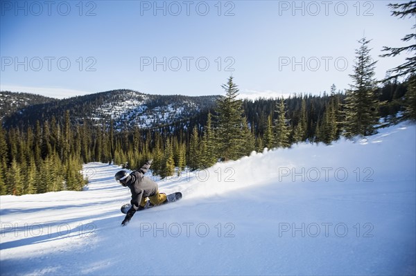 Man snowboarding downhill