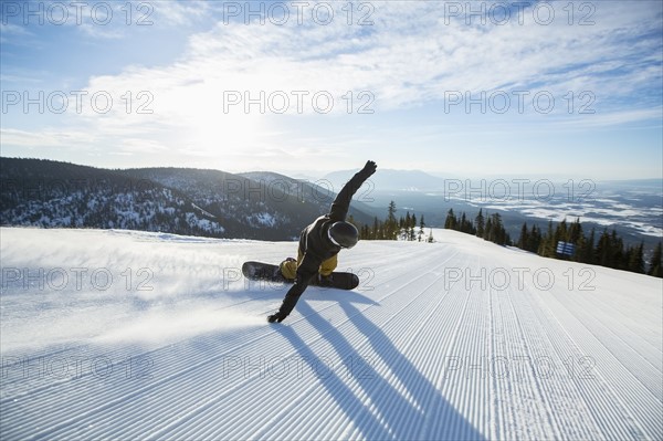 Man snowboarding downhill