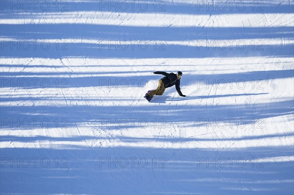 Man snowboarding downhill