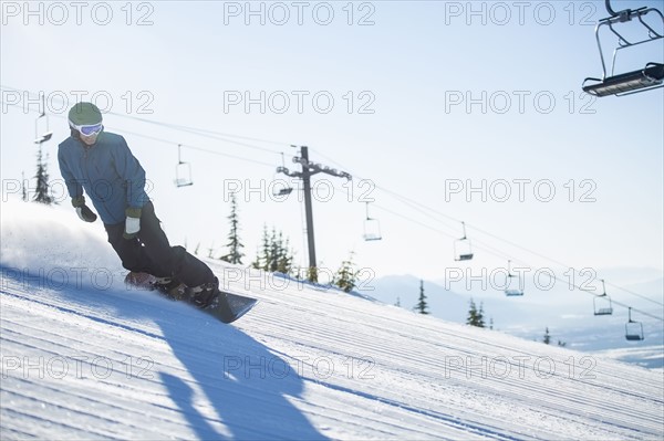 Man snowboarding downhill