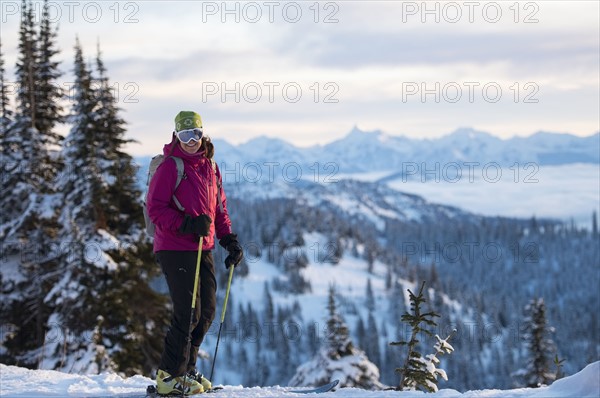 Female skier against mountains