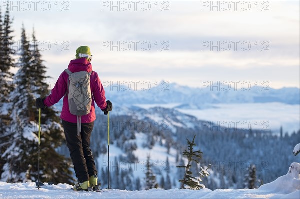 Female skier against mountains