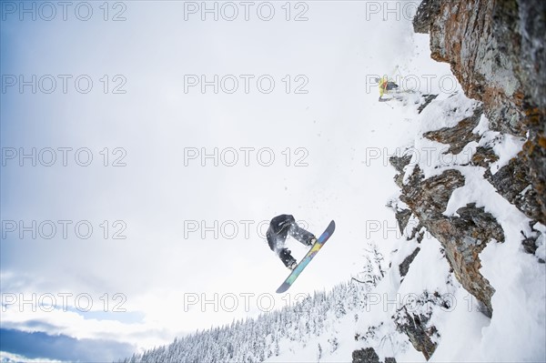 Low angle view of two men jumping from ski slope