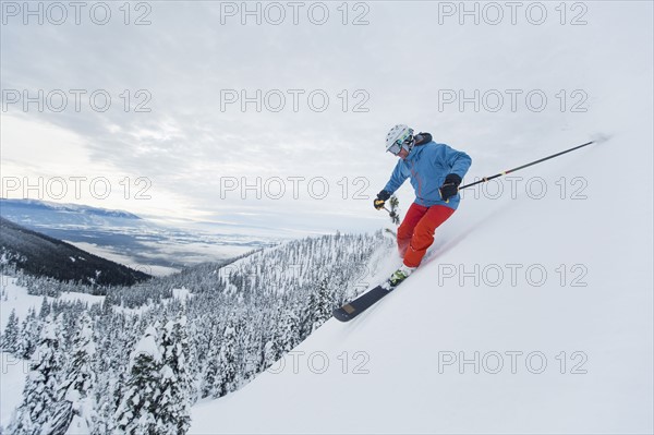 Mature man speeding on ski slope