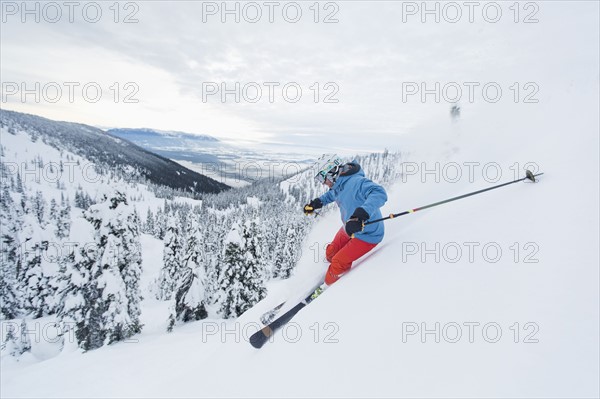 Mature man speeding on ski slope