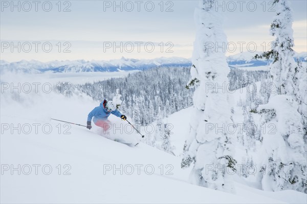 Mature man speeding on ski slope