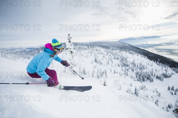 Mature woman speeding on ski slope