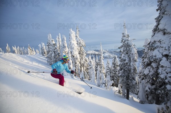 Mature woman speeding on ski slope