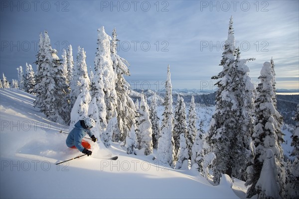 Mature man on ski slope at sunset