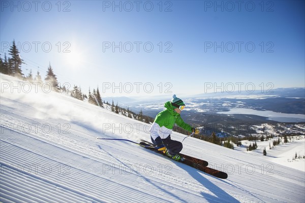 Mature man on ski slope at sunlight