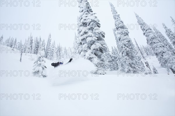 Mature man on ski slope at sunset