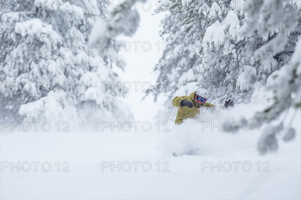 Mature man on ski slope at sunset