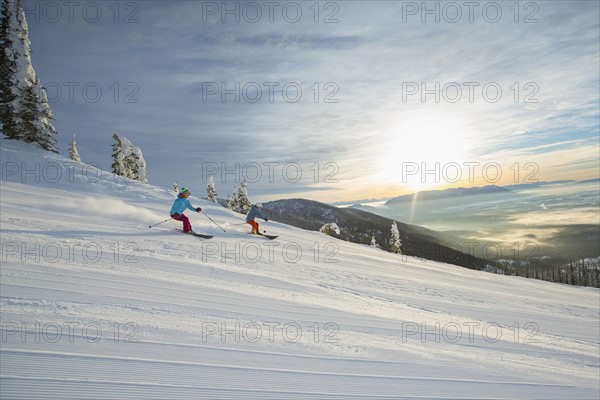 Couple skiing at sunset