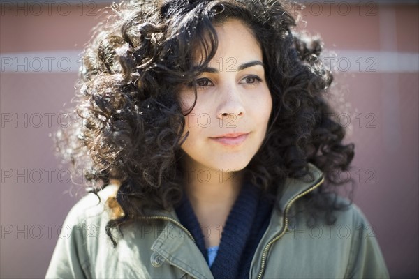 Portrait of woman with dark curly hair