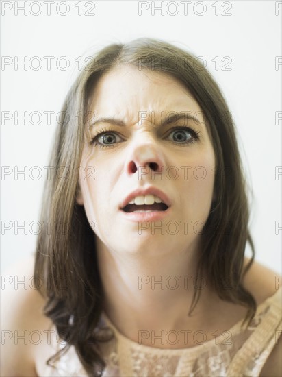 Woman making funny face on glass