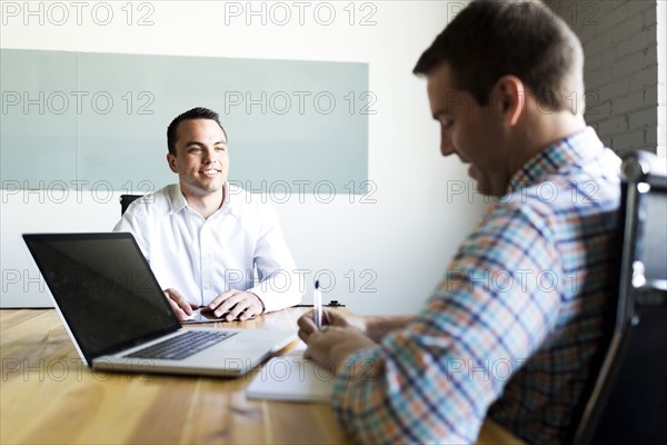 Man being interviewed in conference room