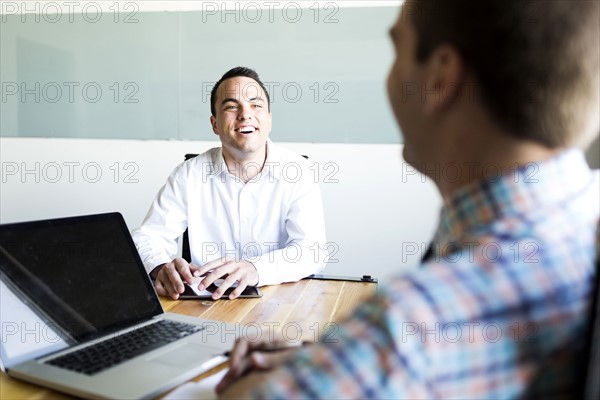 Man being interviewed in conference room