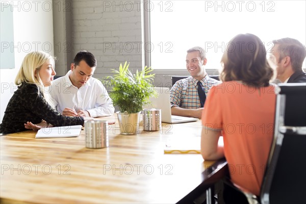 Five office workers during meeting