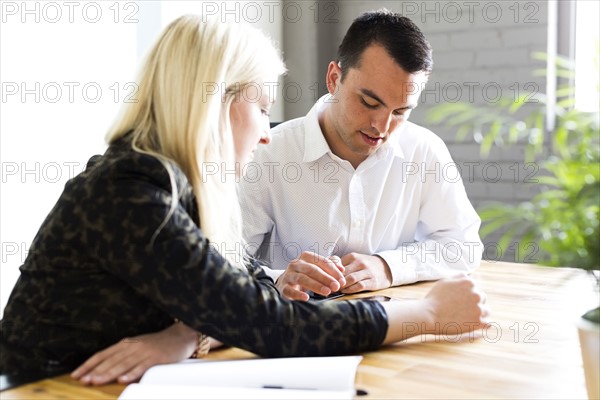 Woman discussing idea with man