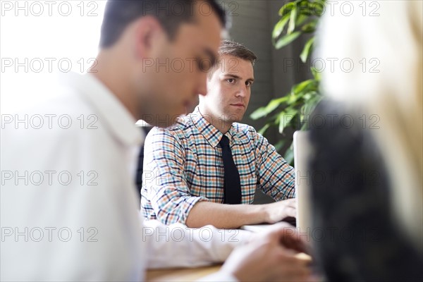 Three office workers during meeting