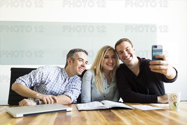 Office workers taking selfie