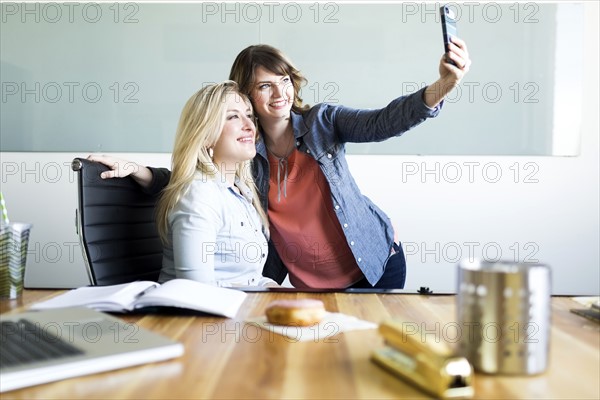 Office workers taking selfie