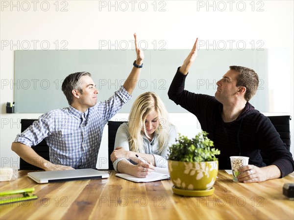 Office workers witting and working at desk