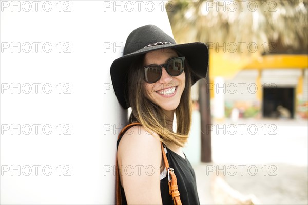 Portrait of woman wearing hat and sunglasses