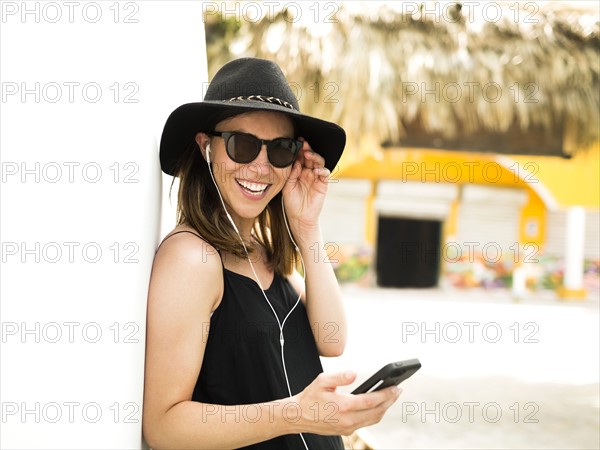 Portrait of woman wearing hat and sunglasses