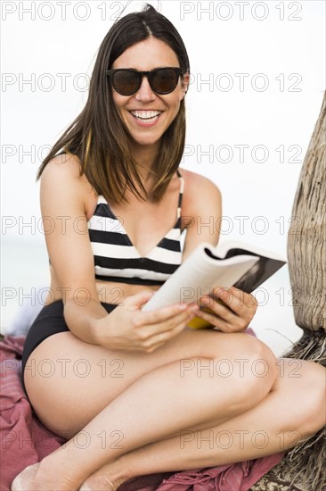 Woman reading on beach