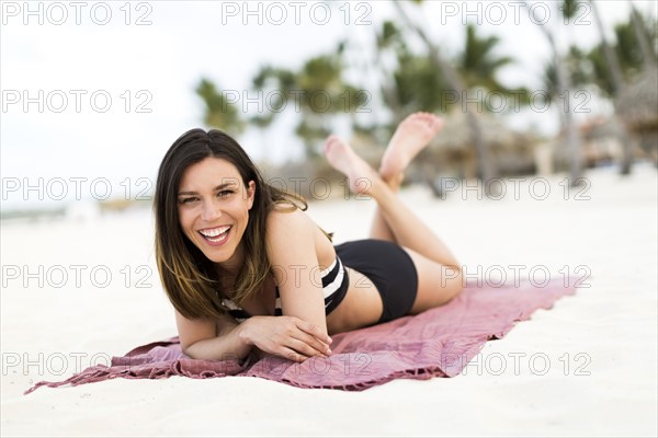 Woman in bikini relaxing on beach