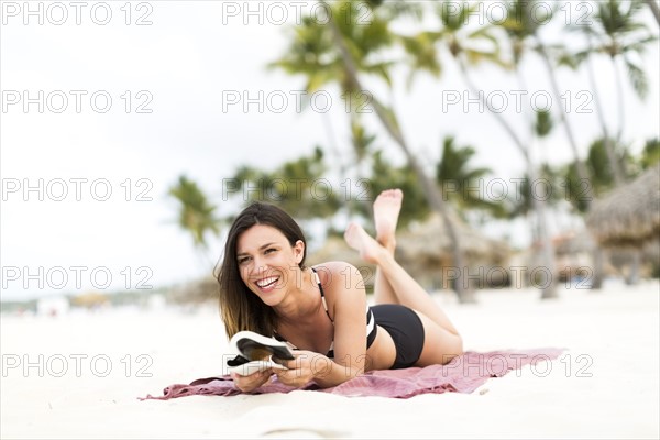 Woman in bikini relaxing on beach