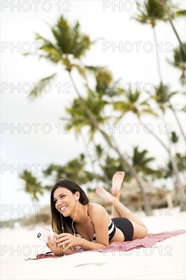 Woman in bikini relaxing on beach