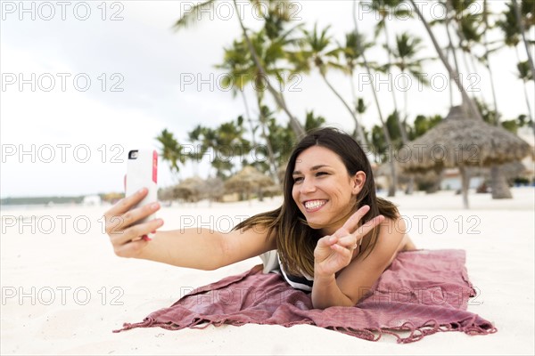 Woman in bikini relaxing on beach