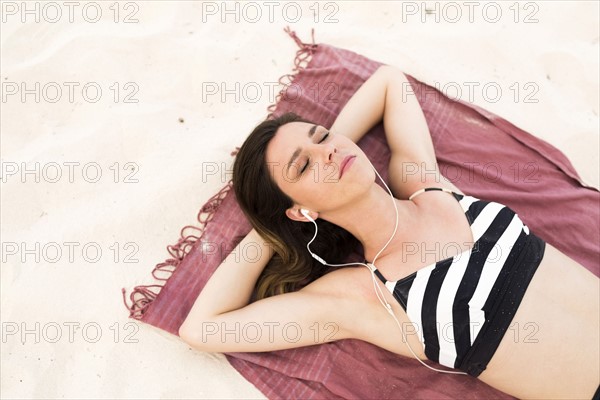 Woman in bikini relaxing on beach