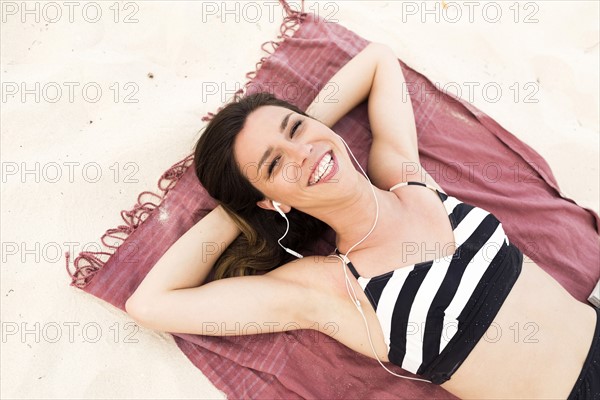 Woman in bikini relaxing on beach