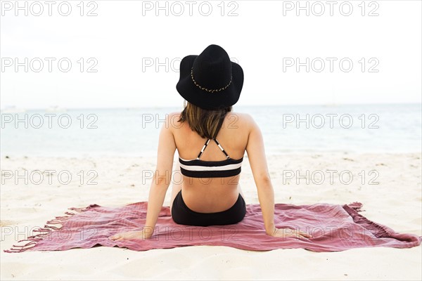 Woman in bikini relaxing on beach