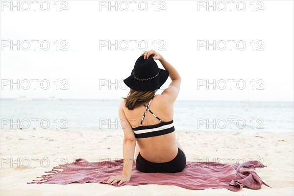 Woman in bikini relaxing on beach