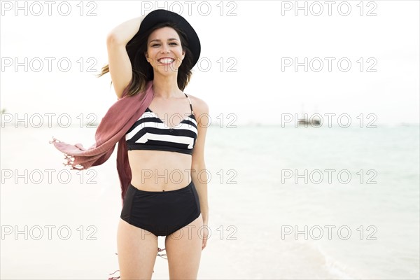 Woman in bikini relaxing on beach