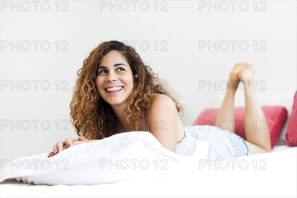 Woman lying on bed