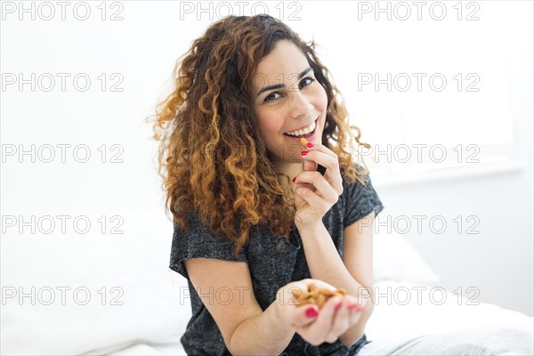 Woman eating almonds